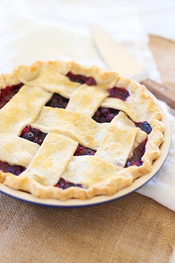 Easy and delicious homemade flaky and crumbly pie with sweet and delicious triple berry filling.