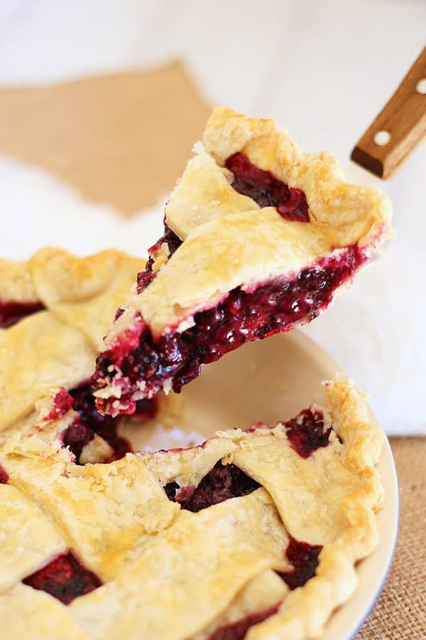 Delicious baked flaky and crumbly pie with sweet and delicious triple berry filling, ready to serve.