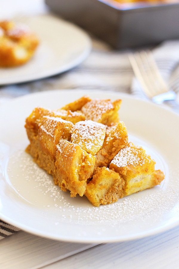 Easy and delicious homemade pumpkin bread pudding in a plate, dusted with flour.