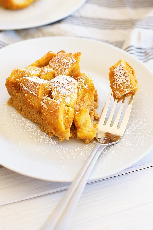 Easy and quick pumpkin bread pudding made with pumpkin spice and egg custard served in a plate with a fork.