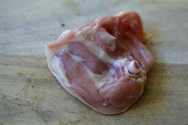 Learn the easy step-by-step to debone chicken thighs so you keep the skin on, but with no bones | rasamalaysia.com