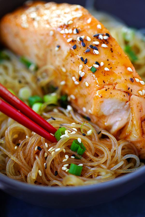 Close up of Salmon Teriyaki with rice noodles in a bowl.