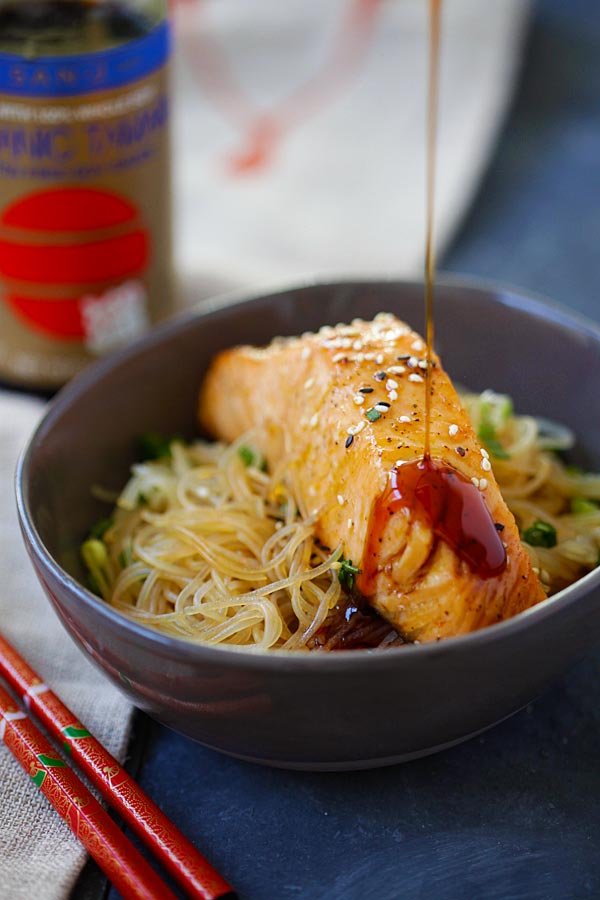 Healthy moist and juicy Salmon Teriyaki Noodles with San-J teriyaki sauce dripping from above.