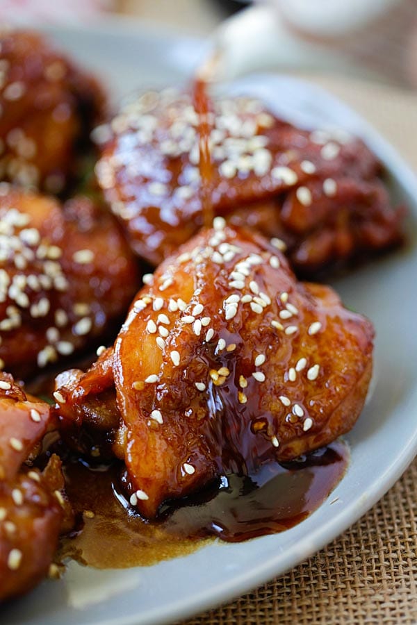 Slow Cooker Sesame Chicken topped with dripping thick brown sauce.