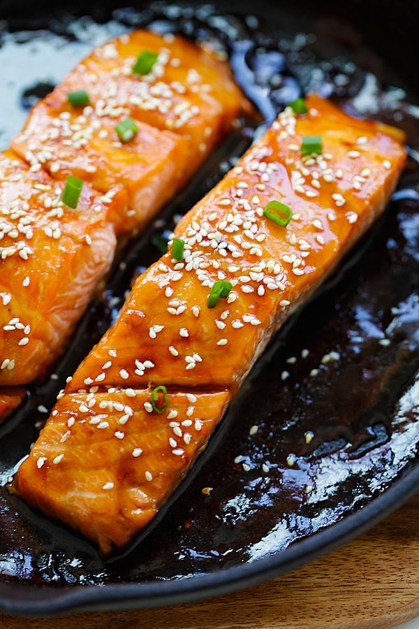 Oven baked Honey Teriyaki Salmon with honey teriyaki sauce garnished in sesame seeds.