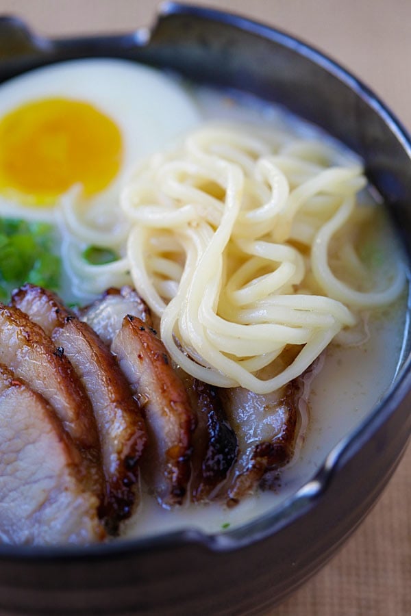 Close up homemade healthy Nissin RAOH ramen with tonkotsu broth topped with delicious Chinese roasted char siu.
