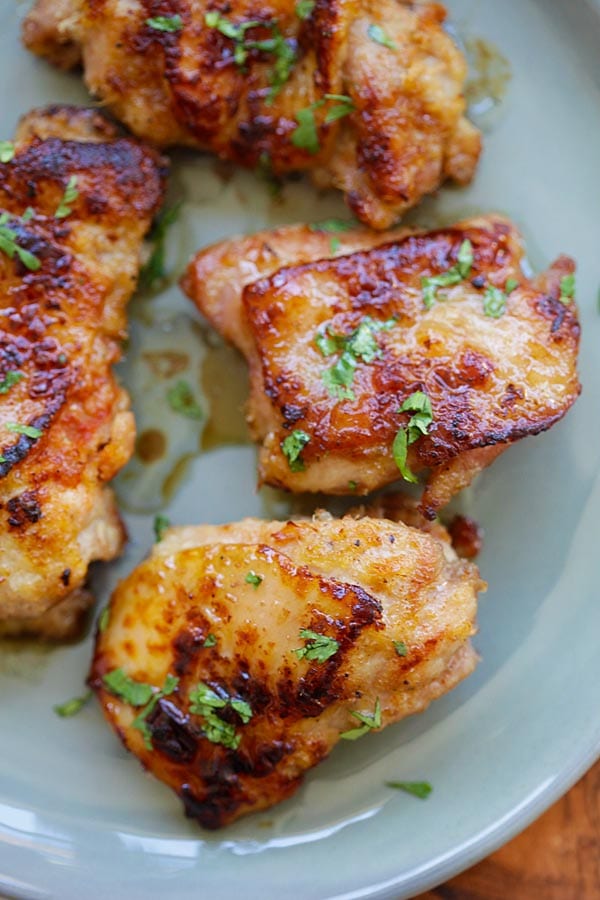 Pan-fried homemade lemongrass chicken thighs in a plate.