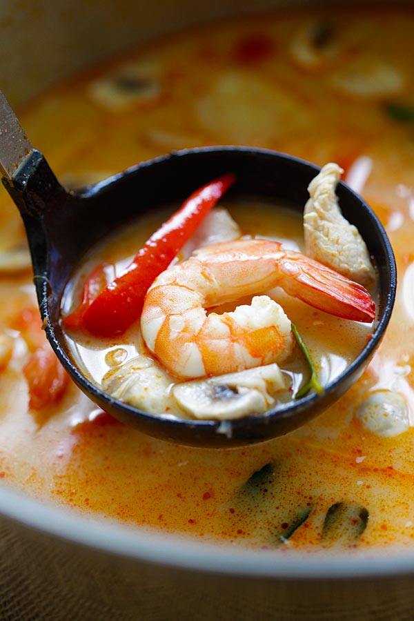 Thai Coconut Chicken and Shrimp Soup scoop with a soup ladle.
