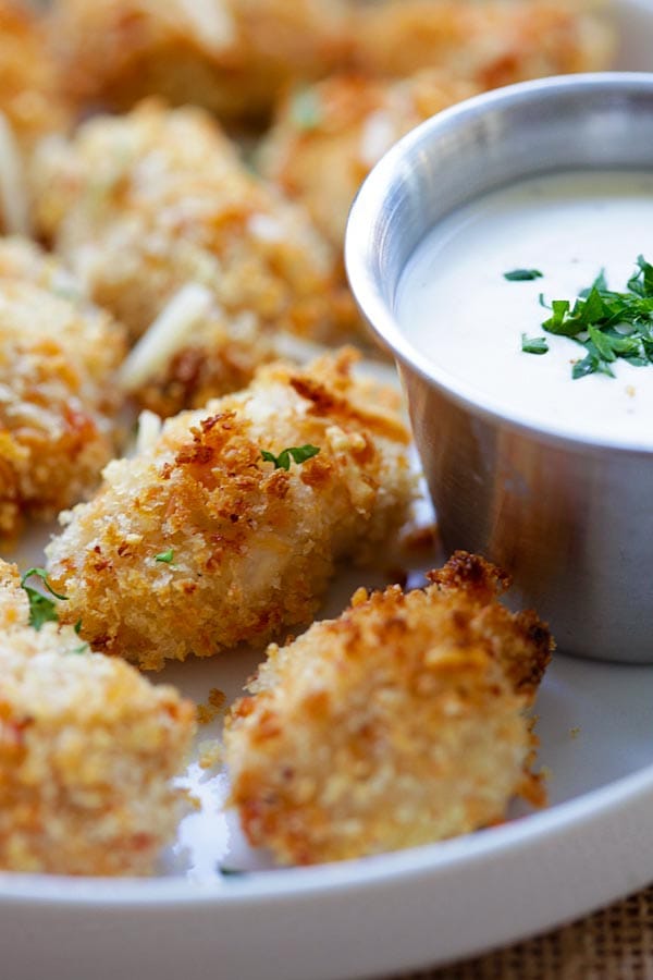 Close up crispy chicken nugget bites marinade with Parmesan cheese, ranch sauce and breadcrumbs.