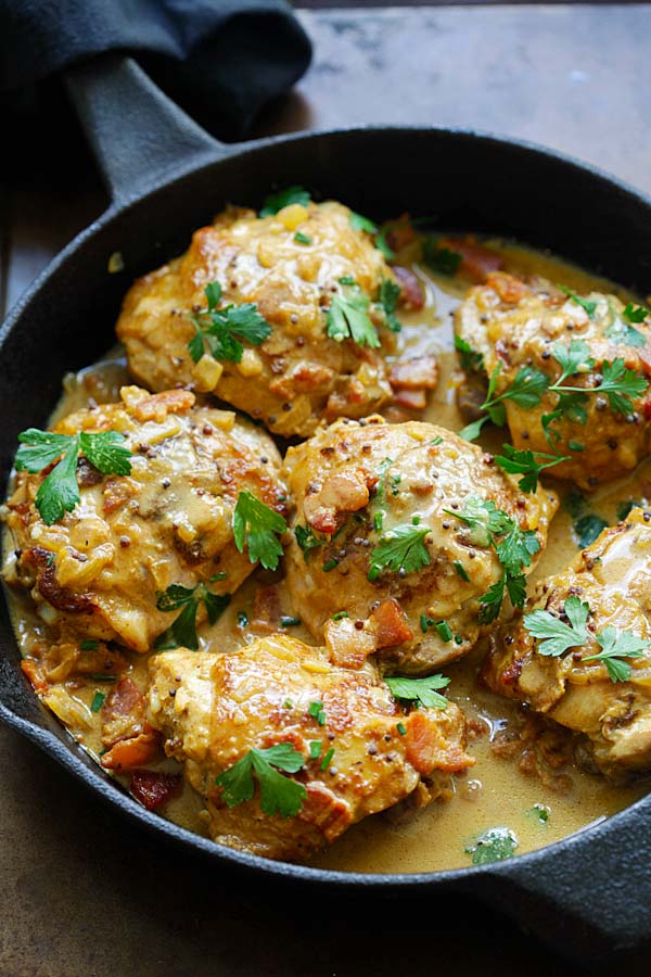 Mustard chicken marinade with creamy mustard sauce in a skillet.