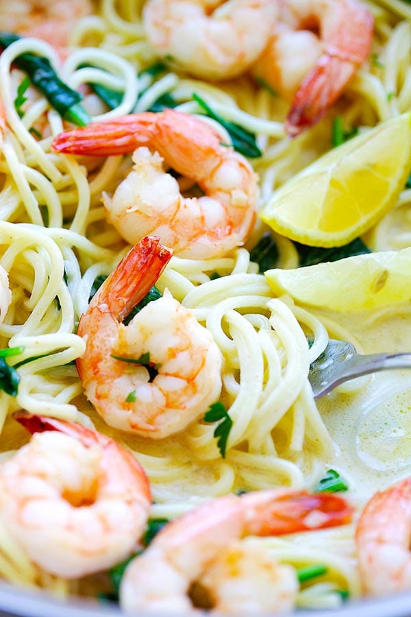 Close up easy shrimp pasta recipe with shrimp, spaghetti in a creamy white sauce and spinach.