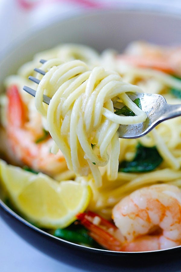 Healthy easy shrimp and spinach spaghetti twirled with a fork.