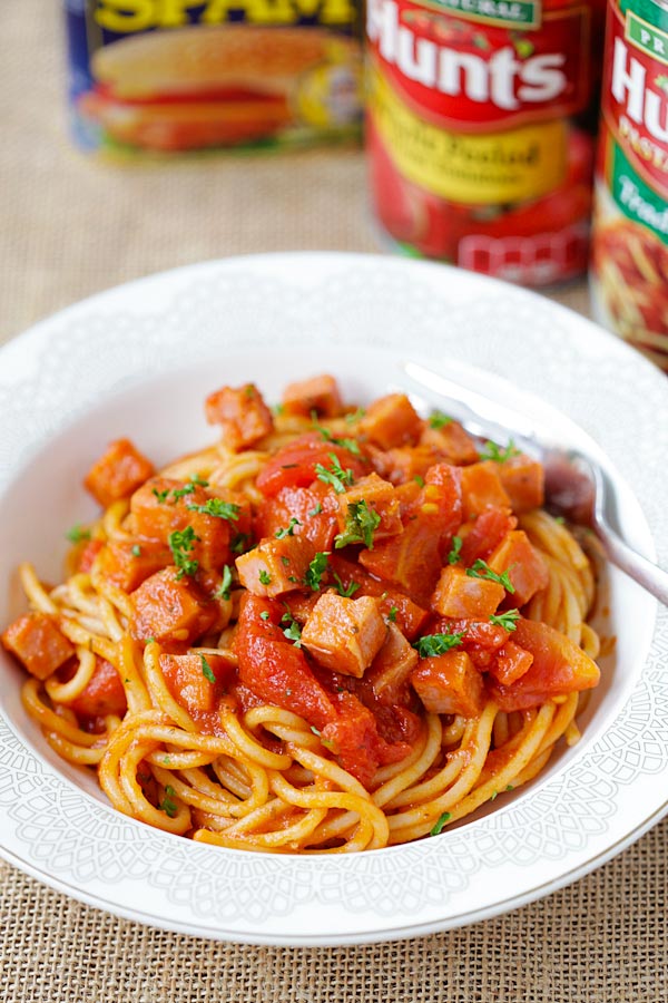 Easy spam Spaghetti with tomato sauce served in a spaghetti plate.