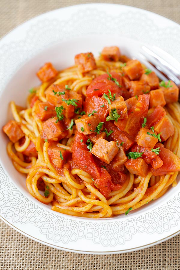 Homemade easy tomato sauce spaghetti with spam meat in a plate.