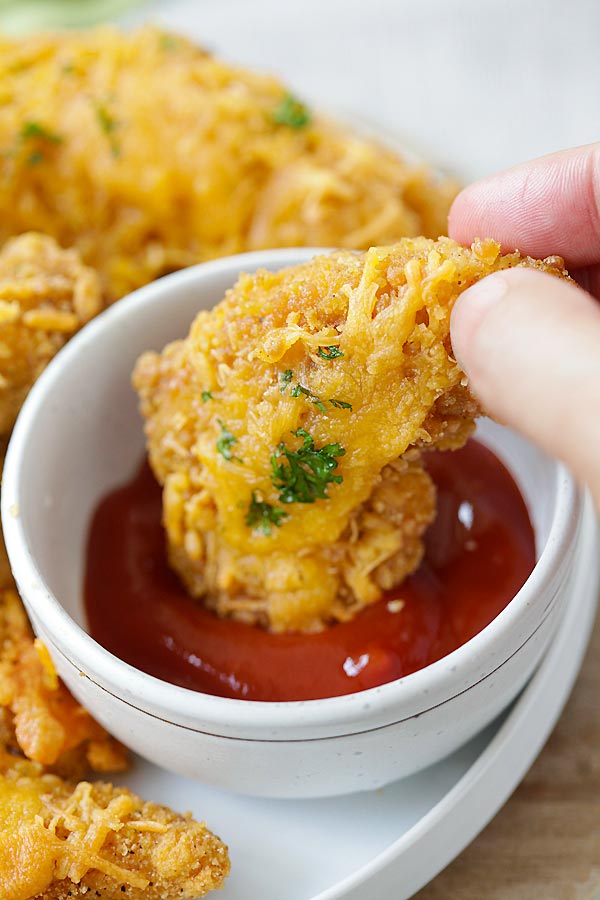 Easy homemade Garlic Cheddar Chicken Strips dipped into ketchup sauce.