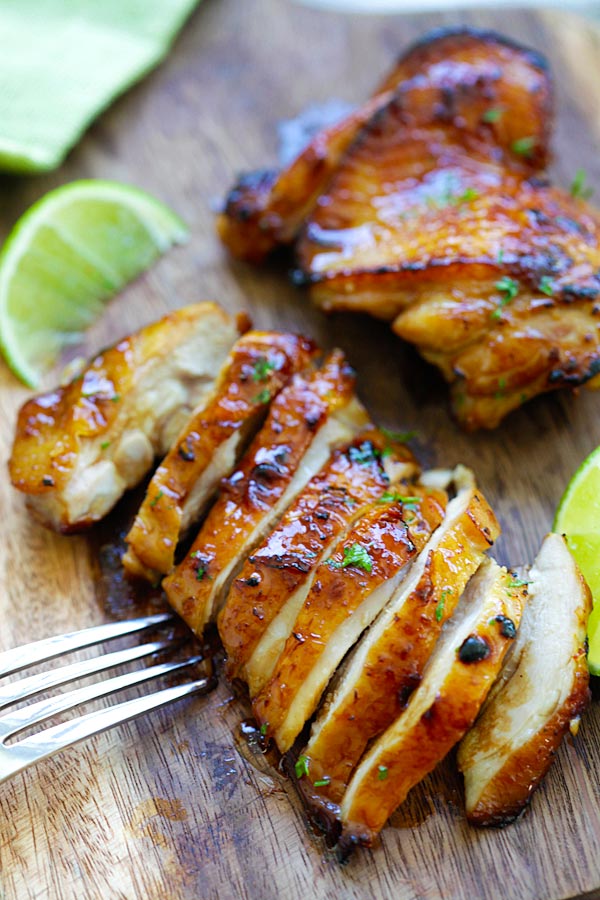 Sliced Honey Lime Chicken on a wooden chopping board.