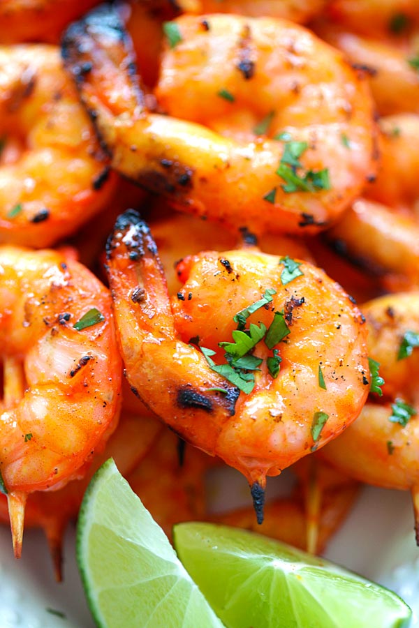 Close up easy and delicious Indian Tandoori Shrimp skewers in orange tandoori glaze.