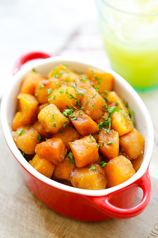 Quick and easy honey balsamic butternut squash in a red serving dish.