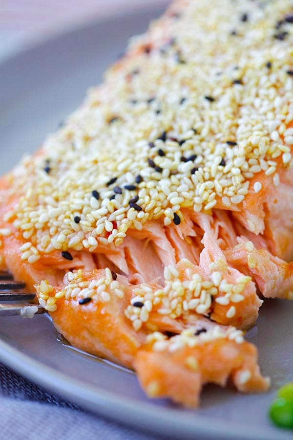 Sesame salmon fillet cut open with a fork, ready to serve.