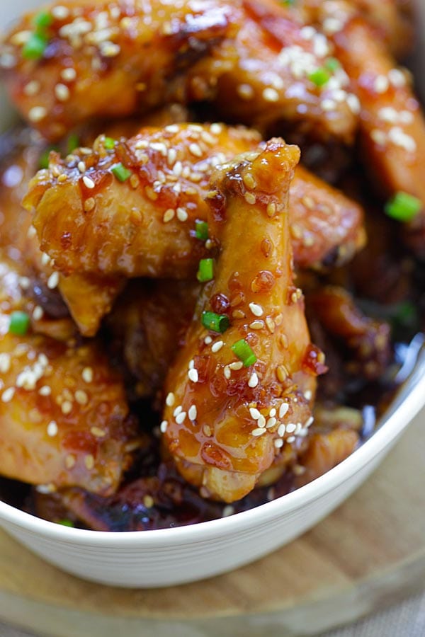 Close up sweet, savory and garlicky crock pot chicken wings cooked in a slow cooker.