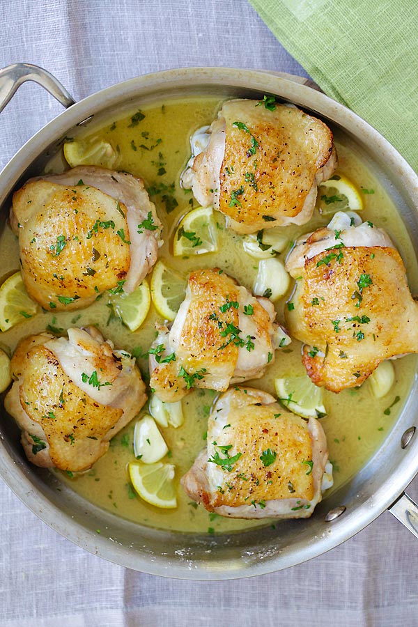 Lemon Chicken, featuring thighs in lemon butter glaze, in a pot.