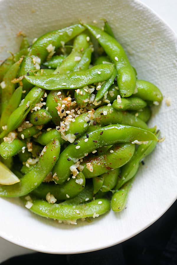 Garlic butter edamame topped with sesame seeds in a bowl.