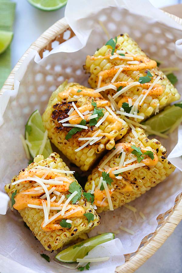 Easy and quick recipe for Mexican street corn with Chipotle seasoning, spicy mayo, Parmesan cheese, lime and cilantro.