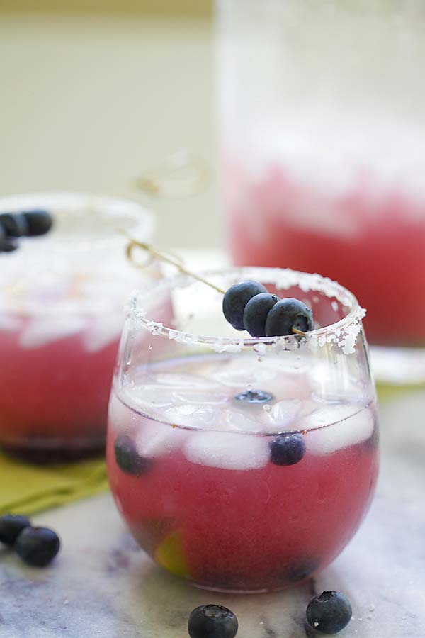 Easy homemade blueberry tequila cocktail in a cocktail glass, ready to serve.