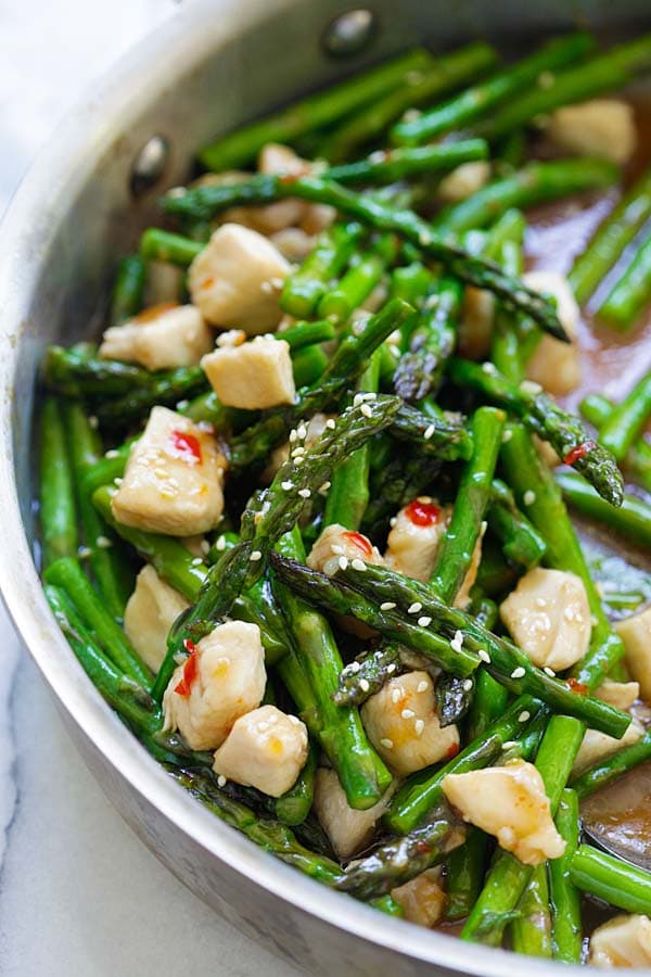 Quick and easy asparagus chicken Asian stir-fry with Asian brown sauce in a skillet.
