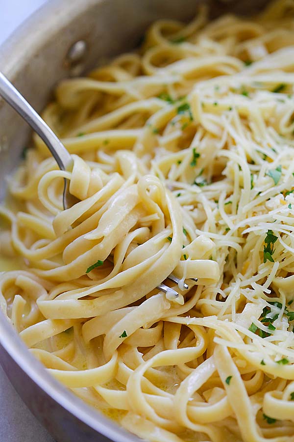 Homemade healthy easy Fettuccine with Creamy Garlic Parmesan sauce with a fork ready to serve.