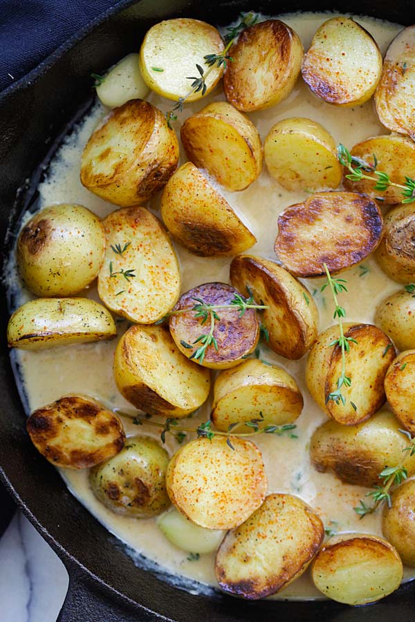 Creamy garlic potatoes garnished with thyme.