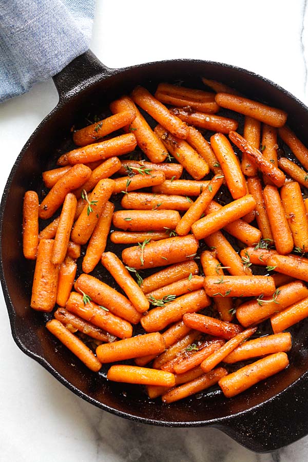 Brown butter garlic honey roasted carrots in a skillet.