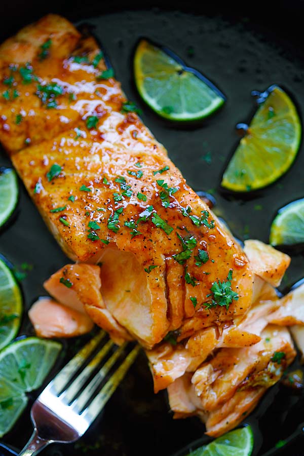 Healthy homemade sweet and zesty salmon with honey, lime juice and soy sauce in a skillet.