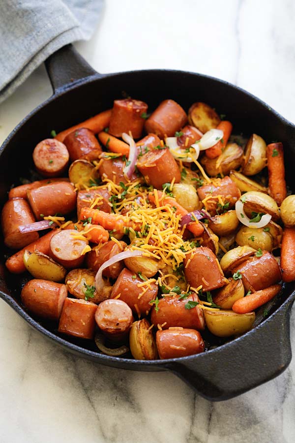 Easy and quick smoked sausage with potatoes and carrots on a skillet.