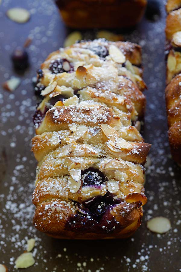 Easy and delicious Blueberry-Cream Cheese Pull-Apart Bread topped with sliced almond nuts and powdered sugar.