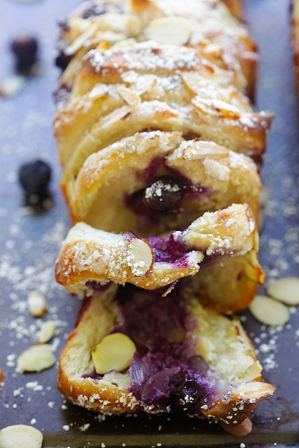 Sliced pull-apart bread loaf loaded with cream cheese and blueberries.