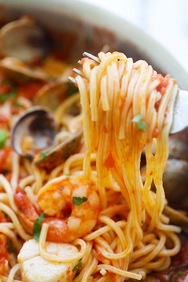 Easy Seafood Pasta with homemade fresh tomato sauce picked on a fork.