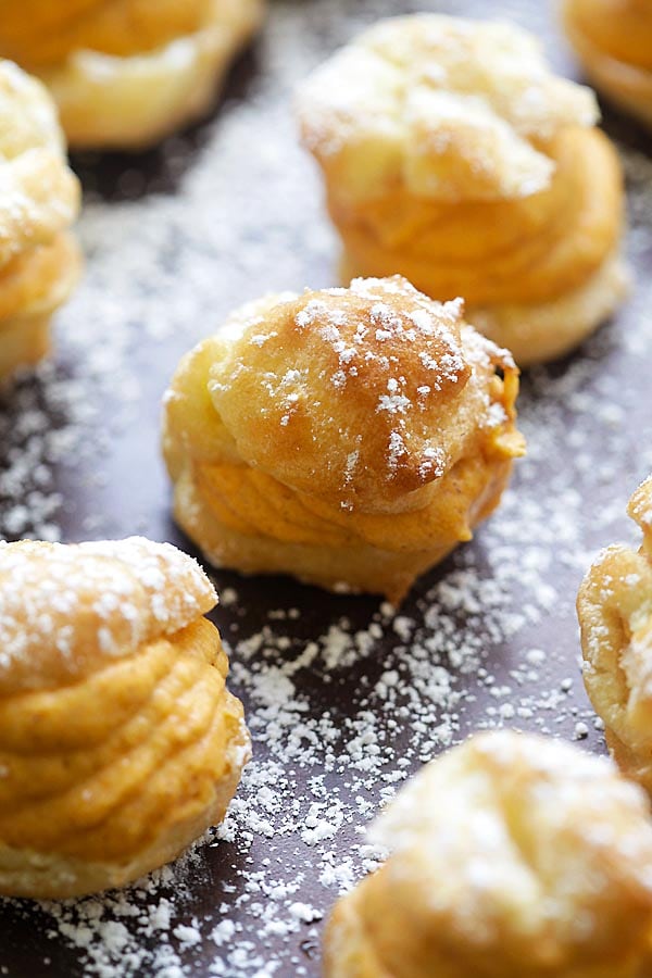 Easy and delicious homemade oven-baked cream puffs pastries made with sweet pumpkin cream.