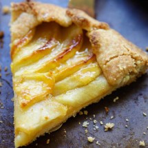 Slice of homemade apple tart on serving spatula.