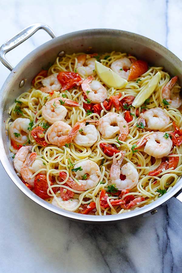 Healthy Italian creamy shrimp and sun-dried tomatoes pasta in a pot.