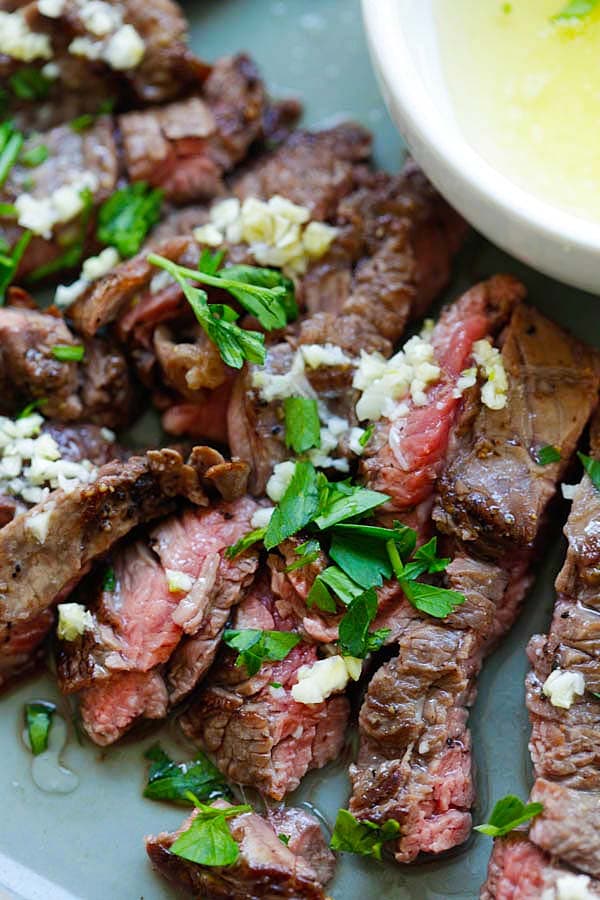 Brazilian steak with golden butter sauce served on a plate.