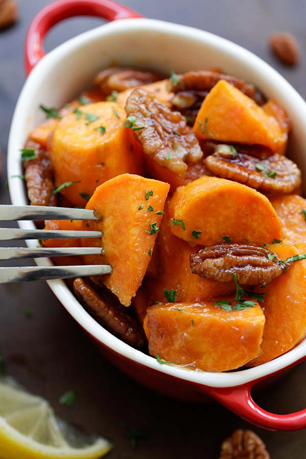 Easy oven-roasted sweet potatoes with a sticky sweet maple glaze and pecan, ready to serve.