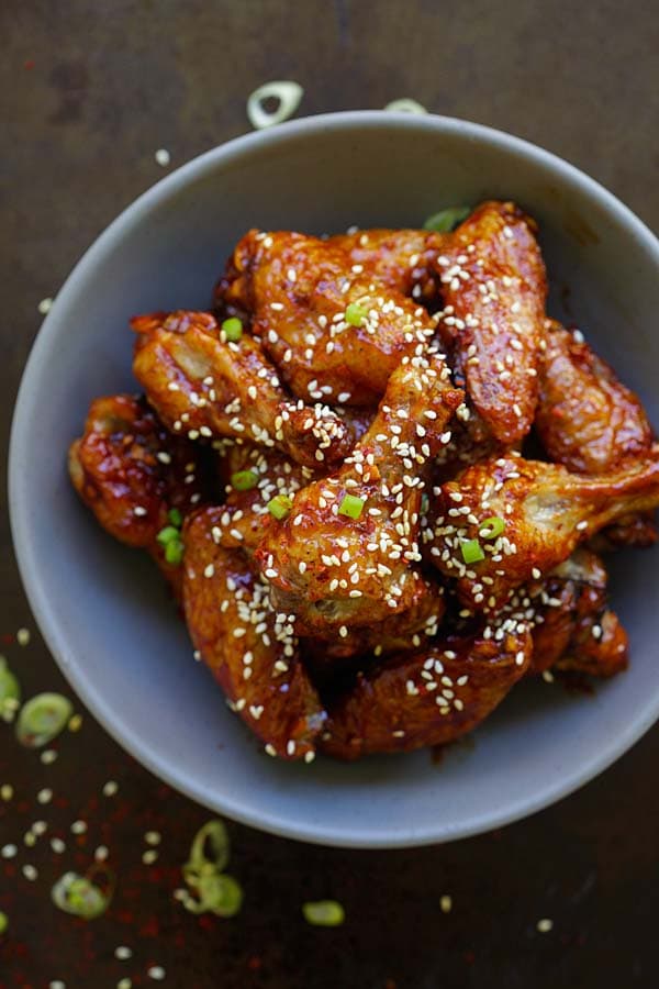 Easy and quick oven baked Korean chicken wings with sweet and savory Korean red pepper sauce in a bowl.