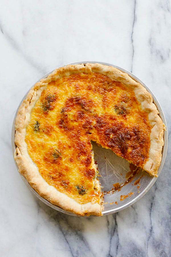 Top down view of easy and delicious baked cheesy ham and broccoli French egg pancake in a pie pan.