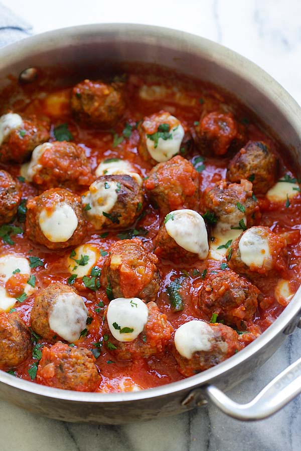 Easy casserole recipe with ground beef meatballs in tomato sauce topped with mozzarella cheese.