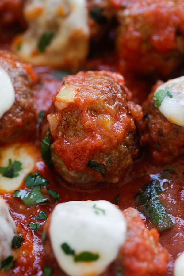 Italian meatballs covered in homemade tomato sauce and mozzarella cheese.