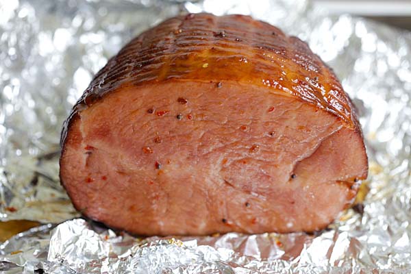 Glazed ham with spicy honey glaze, ready to be sliced.