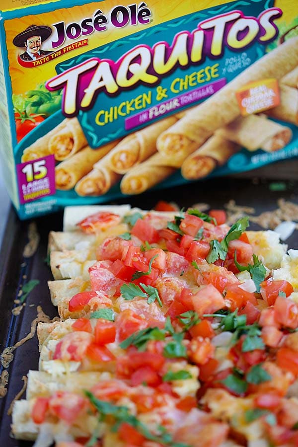 Cheesy Baked Taquitos held in hand and ready to serve.