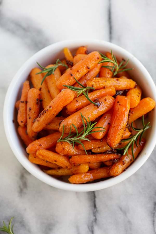Easy and quick homemade maple and dijon mustard roasted carrots served in a bowl.