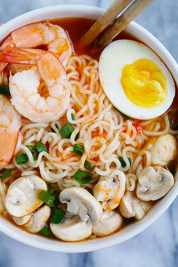 Tasty homemade soup noodles with spicy Sriracha broth, ready to serve.